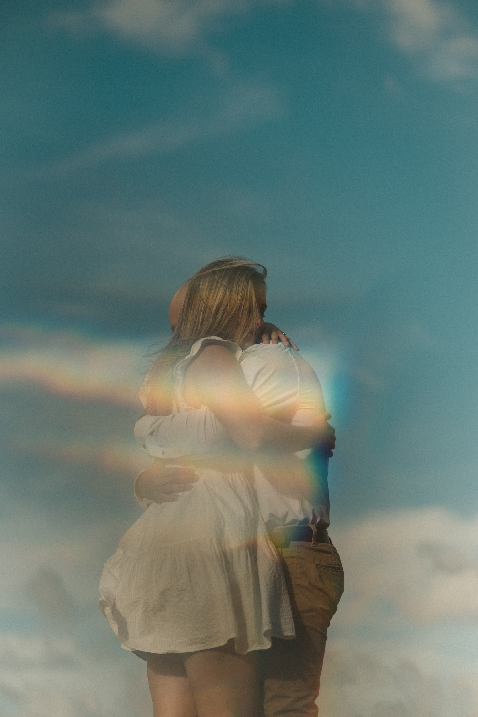 Couple embracing, prism light