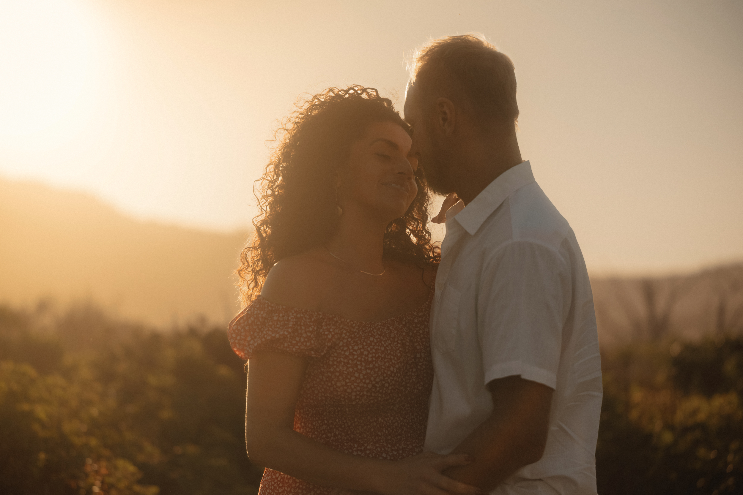 Couple silhouetted in golden backlight
